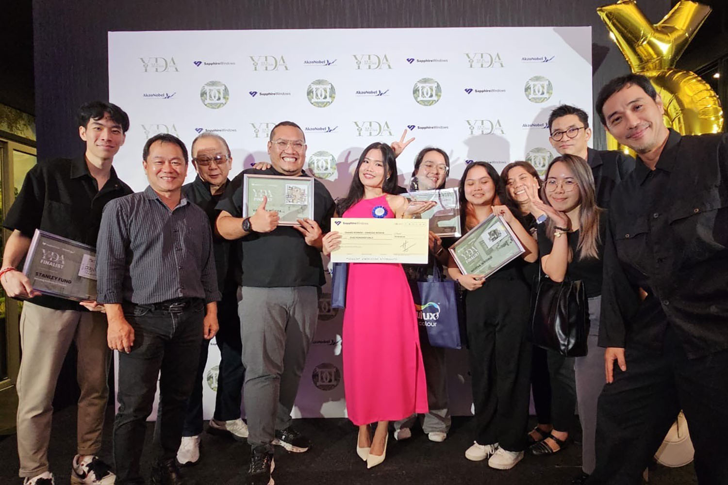 Young Designer Award 2024 group photo. Recipients holding various awards and cash prizes.