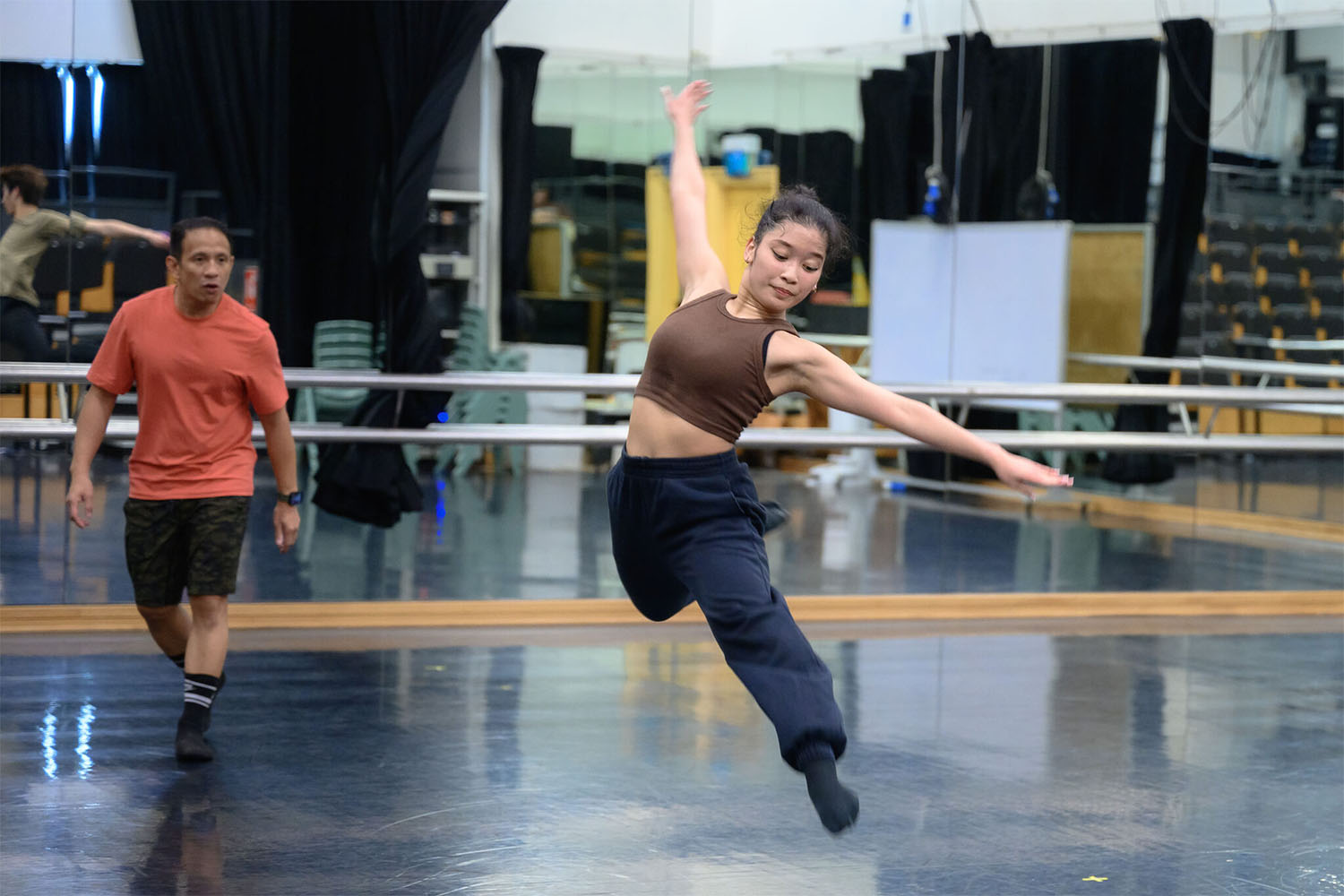 Female performer dancing with both feet off the ground.