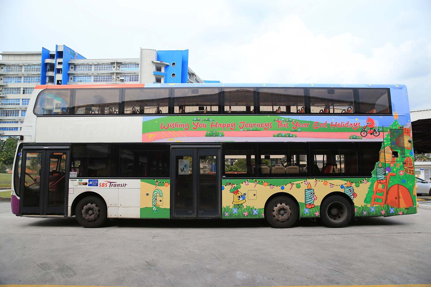 Side profile of a SBS Transit bus with its exterior decorated with Christmas festive illustrations.