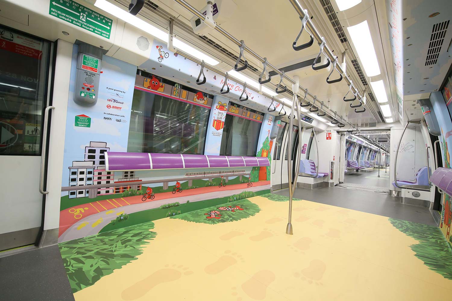 Angled side view of SBS Transit MRT interior decorated with Christmas festive illustrations, the train is empty.