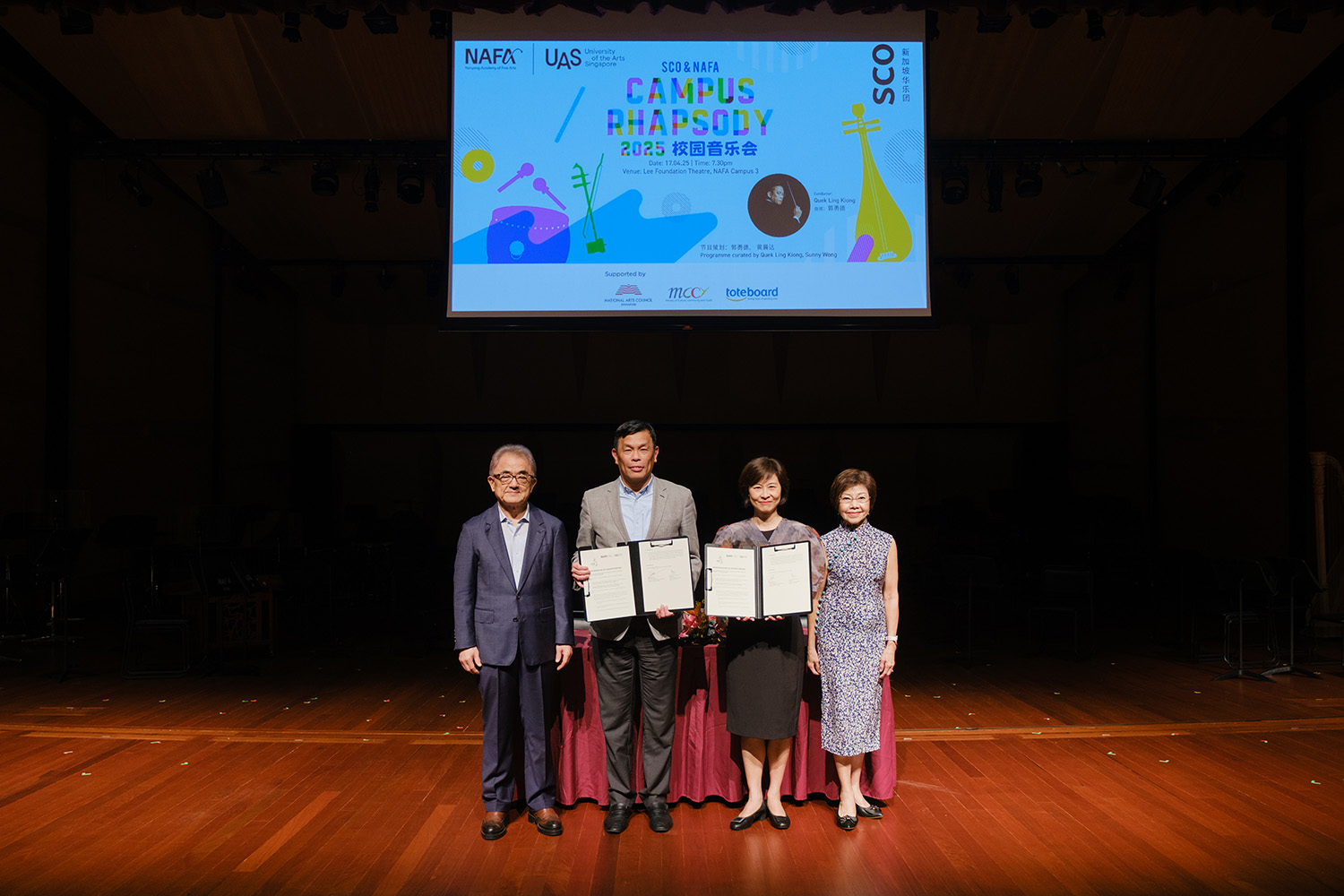 Various staff from Singapore Chinese Orchestra (SCO) and NAFA showing the signed Memorandum of Understanding (MOU) at the Lee Foundation Theatre.