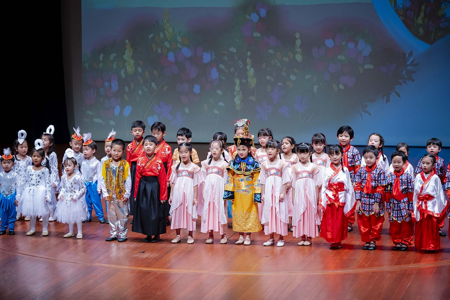 Various preschool K2 young learners in traditional costumes from various religions, customs, and ethnicities.