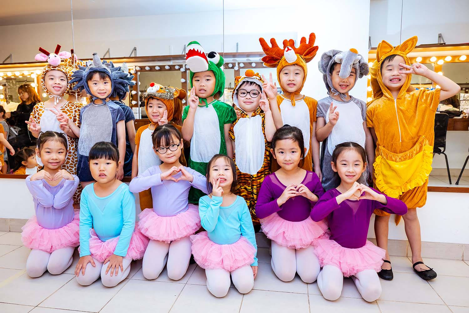 Various preschool K2 young learners, the boys in cute animal costumes, the girls in ballet dancer costumes.