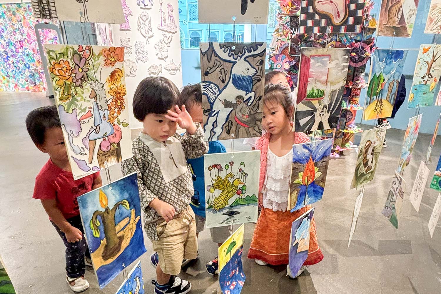 Junior Art students exhibition, displaying various painted pieces.