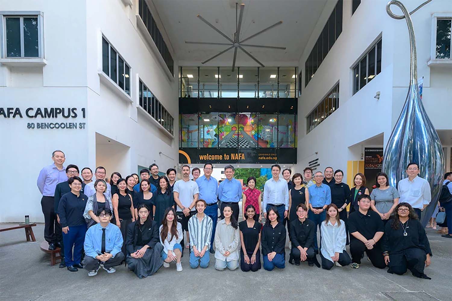 Various staff members and people taking a group photo outside the Childrens Museum Singapore.
