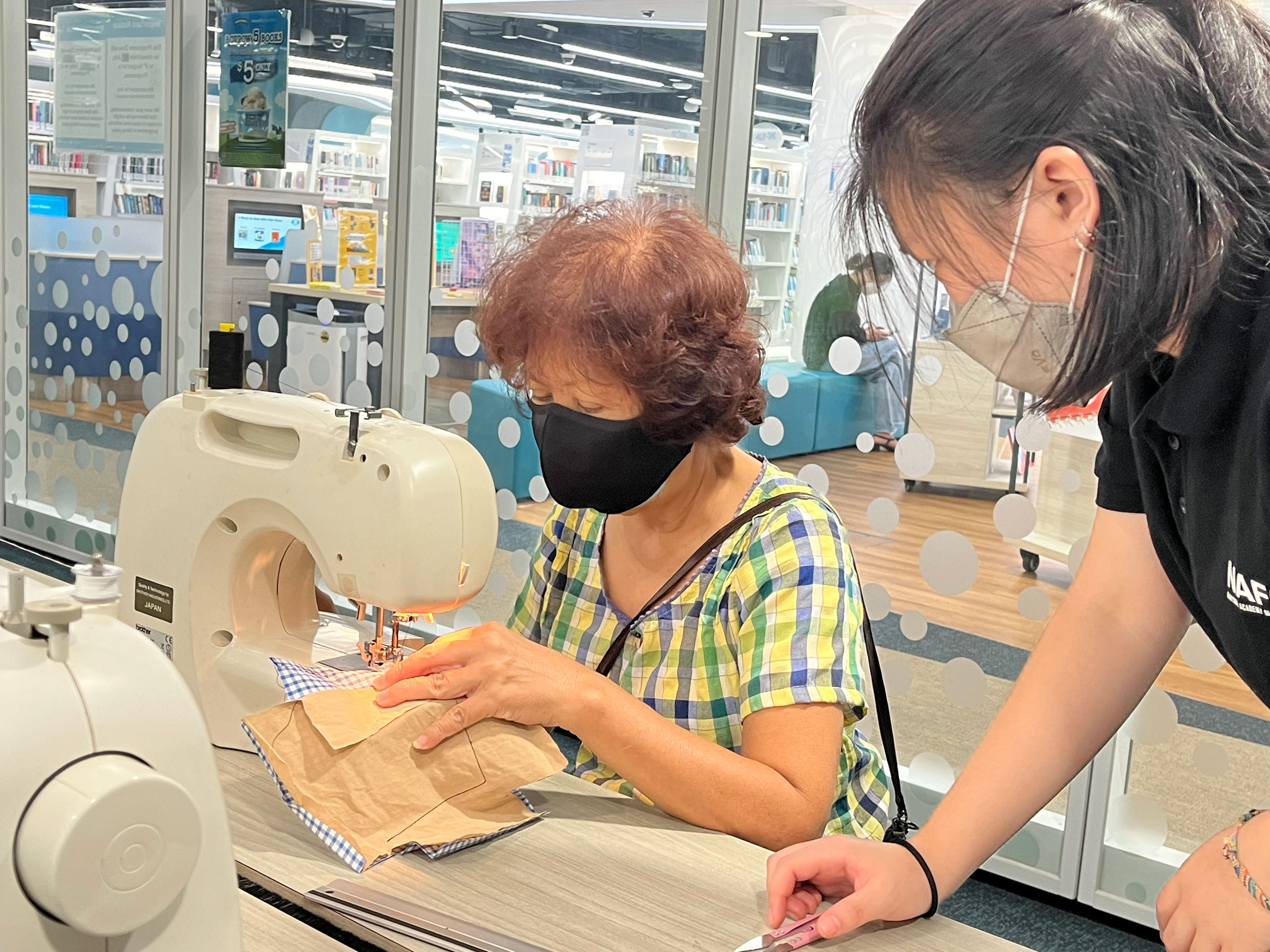 Participant learning to use the sewing machine