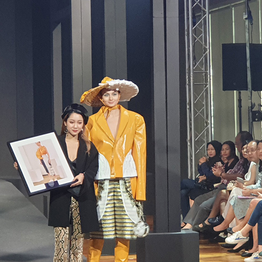 A fashion student presenting her collection at the Fashion Graduation show
